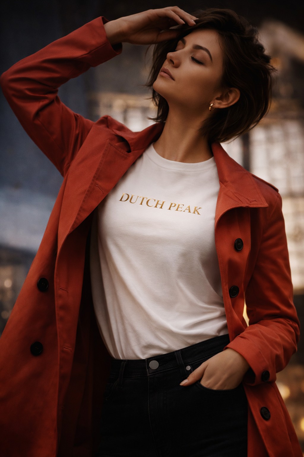 Dutch Peak white t-shirt with gold logo worn with red trench coat, minimalist luxury fashion