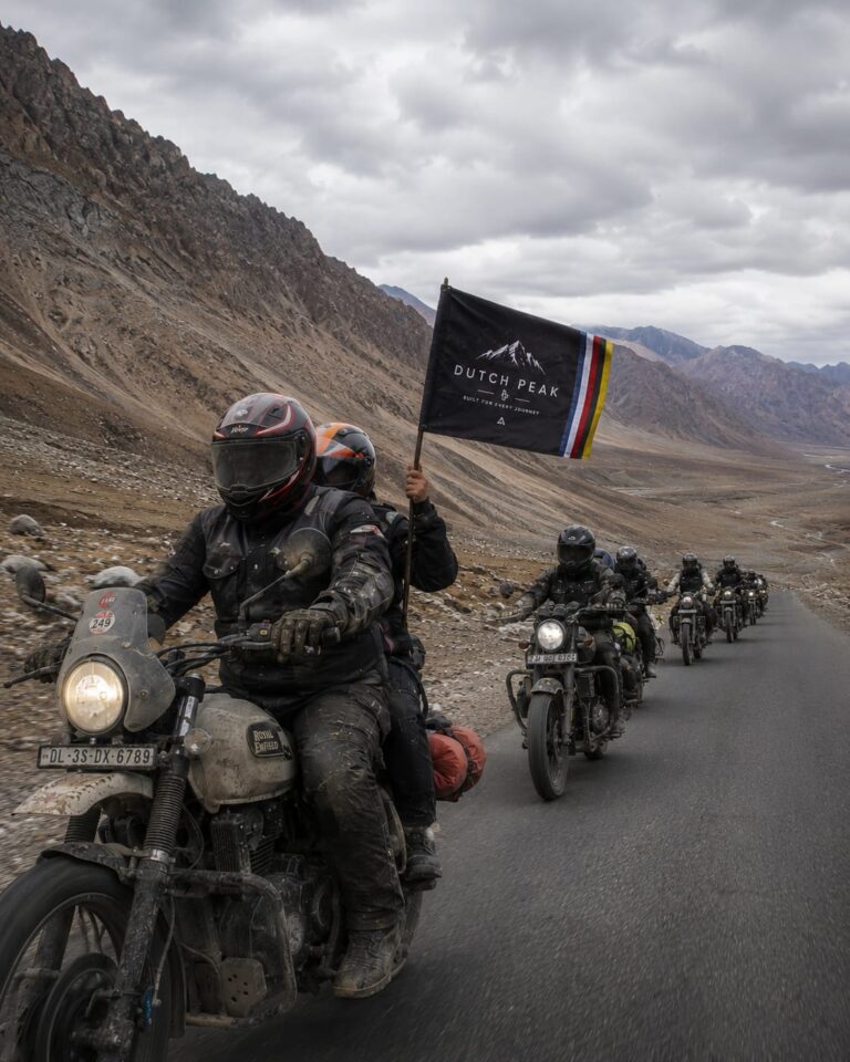 Indian motorcycle rider on ladaki Leh highway carrying Dutchpeak flag